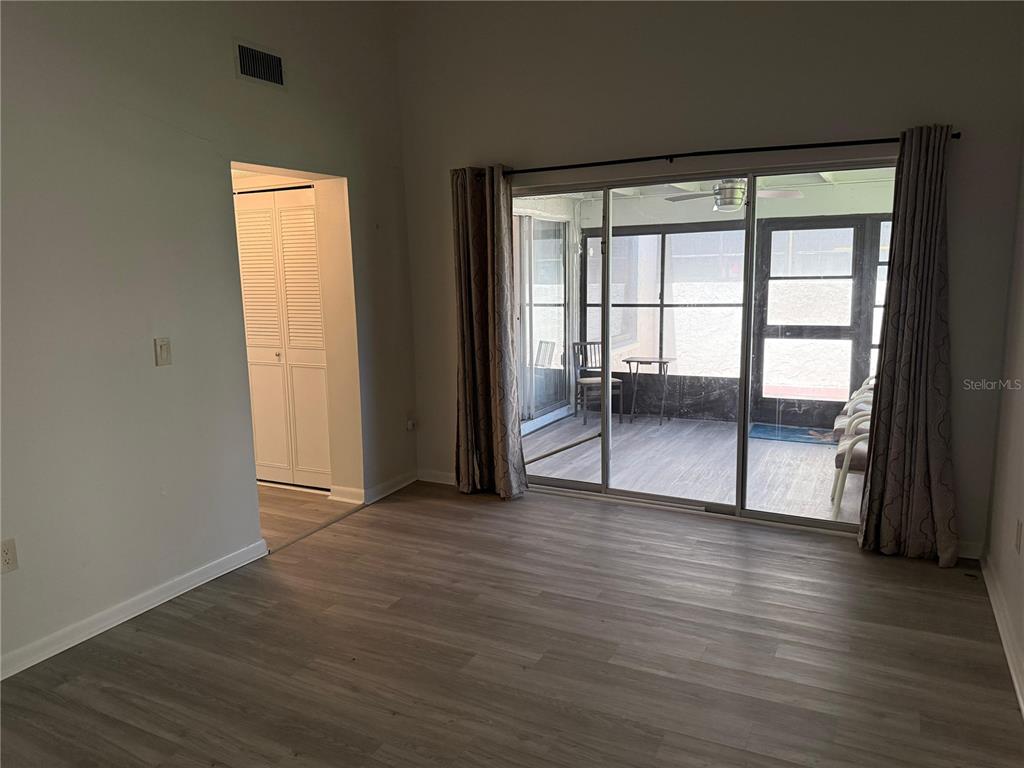 2207 Belleair Road, Unit B22 Clearwater, FL 33764 - Photo 12 of 17 an empty room with wooden floor and windows