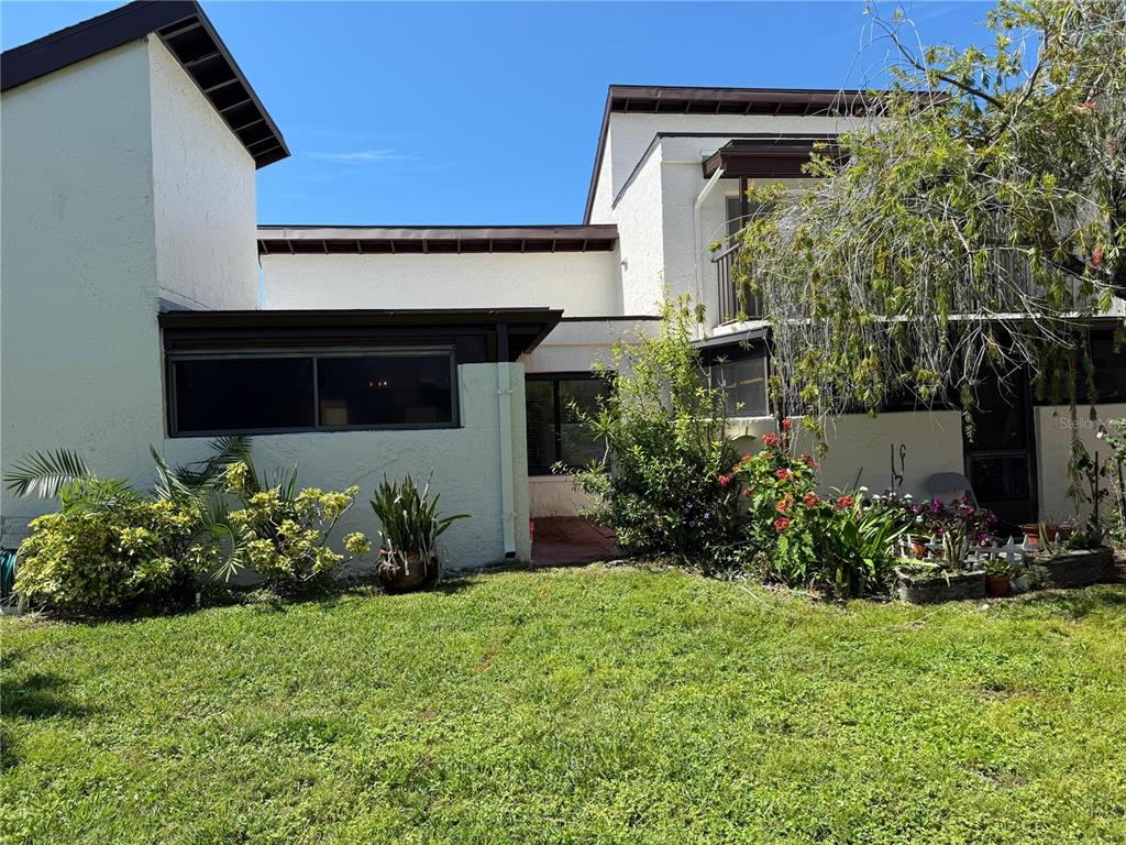 2207 Belleair Road, Unit B22 Clearwater, FL 33764 - Photo 16 of 17 a front view of a house with a yard