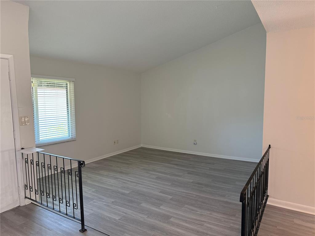 2207 Belleair Road, Unit B22 Clearwater, FL 33764 - Photo 4 of 17 wooden floor in an empty room with a window