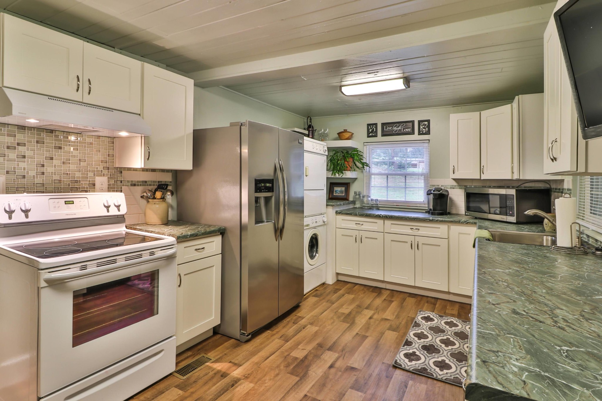712 Park Road Sevierville, TN 37862 - Photo 2 of 9 a kitchen with stainless steel appliances granite countertop a stove a sink and a refrigerator