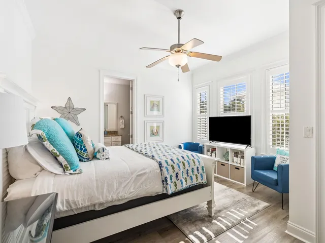 a bedroom with a bed couch and a flat screen tv