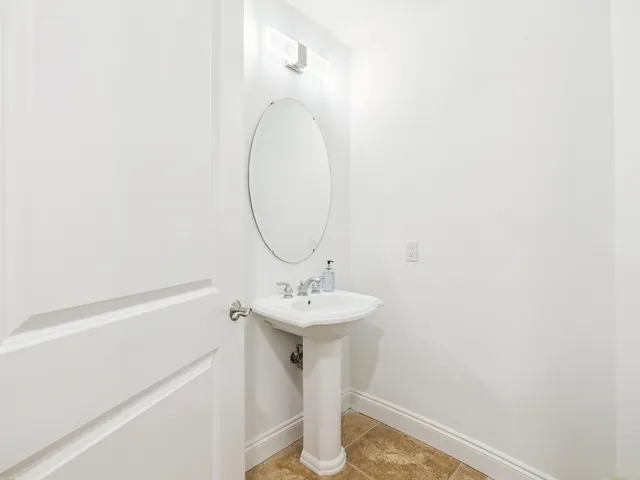 a bathroom with a sink a mirror and vanity