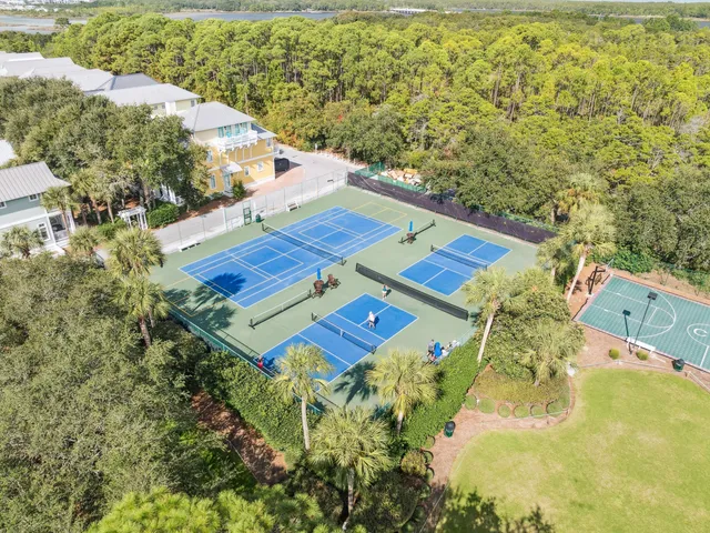 an aerial view of a house with a yard and lake view