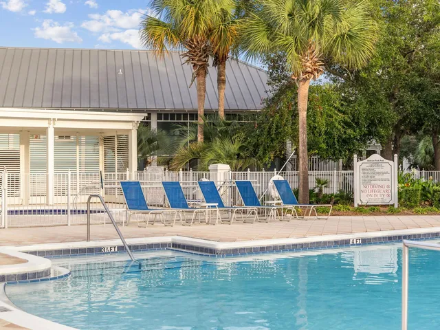 a swimming pool with outdoor seating and yard