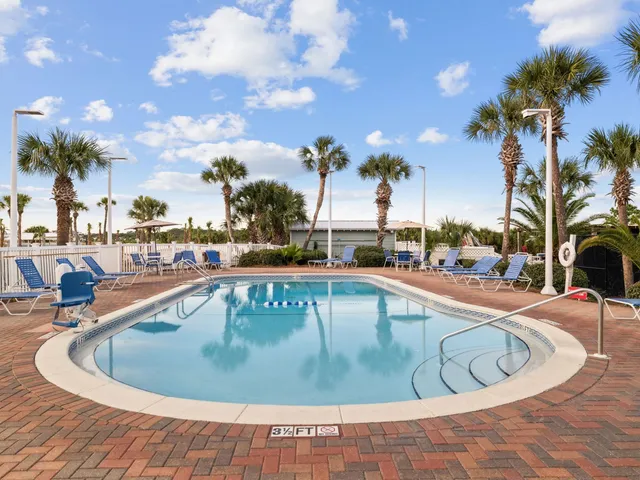 a view of a swimming pool with outdoor seating