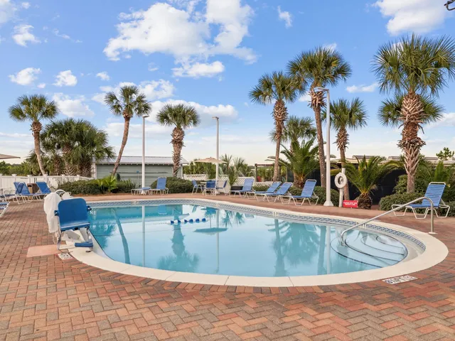 a view of a swimming pool with outdoor seating