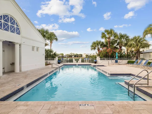 a view of a swimming pool with outdoor seating