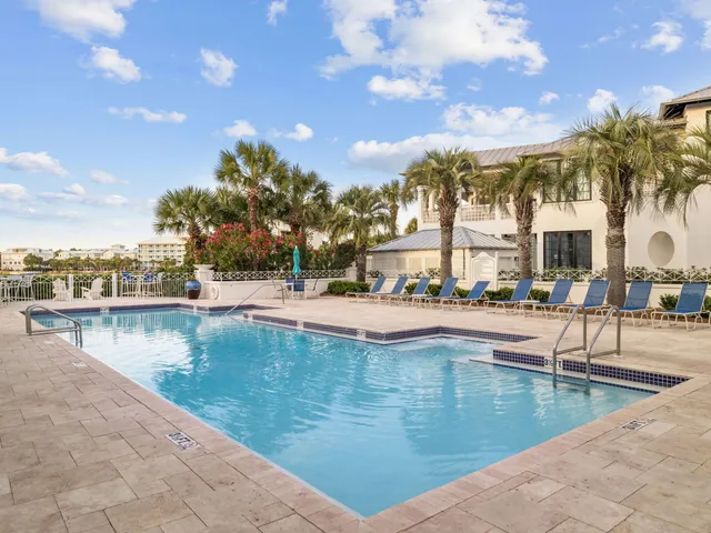 a swimming pool with outdoor seating and yard