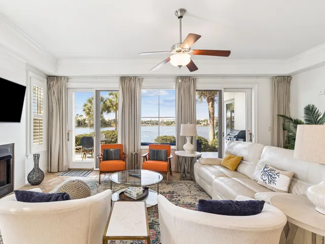 a living room with fireplace furniture and a large window