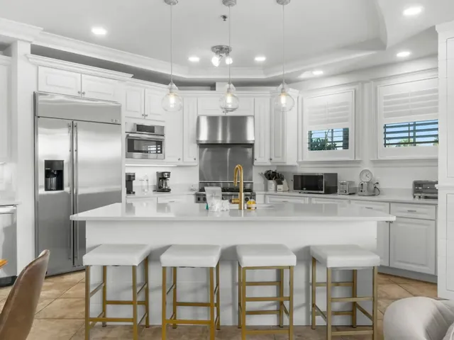 a kitchen with kitchen island cabinets and chairs
