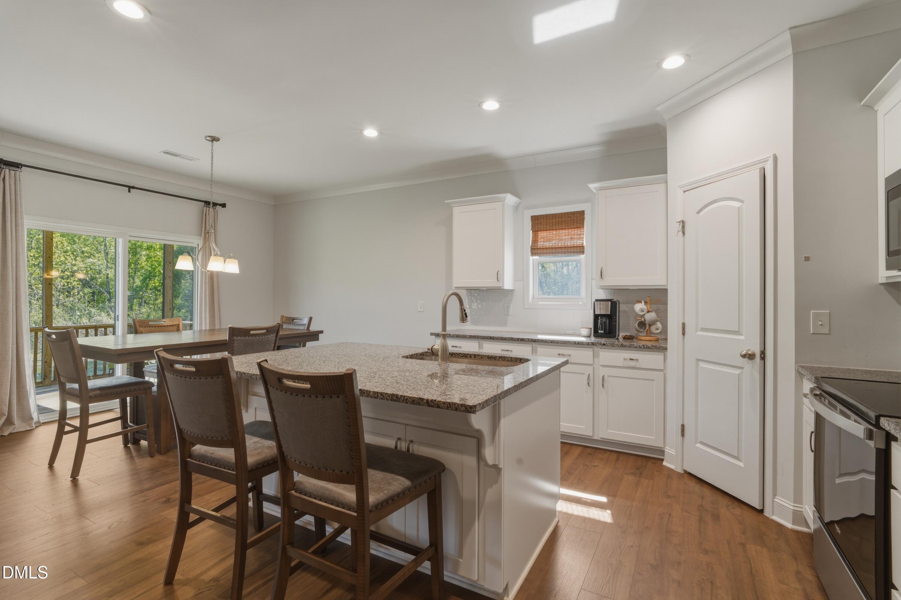 386 Howards Crossing Drive Wendell, NC 27591 - Photo 8 of 31 a kitchen with a table and chairs in it