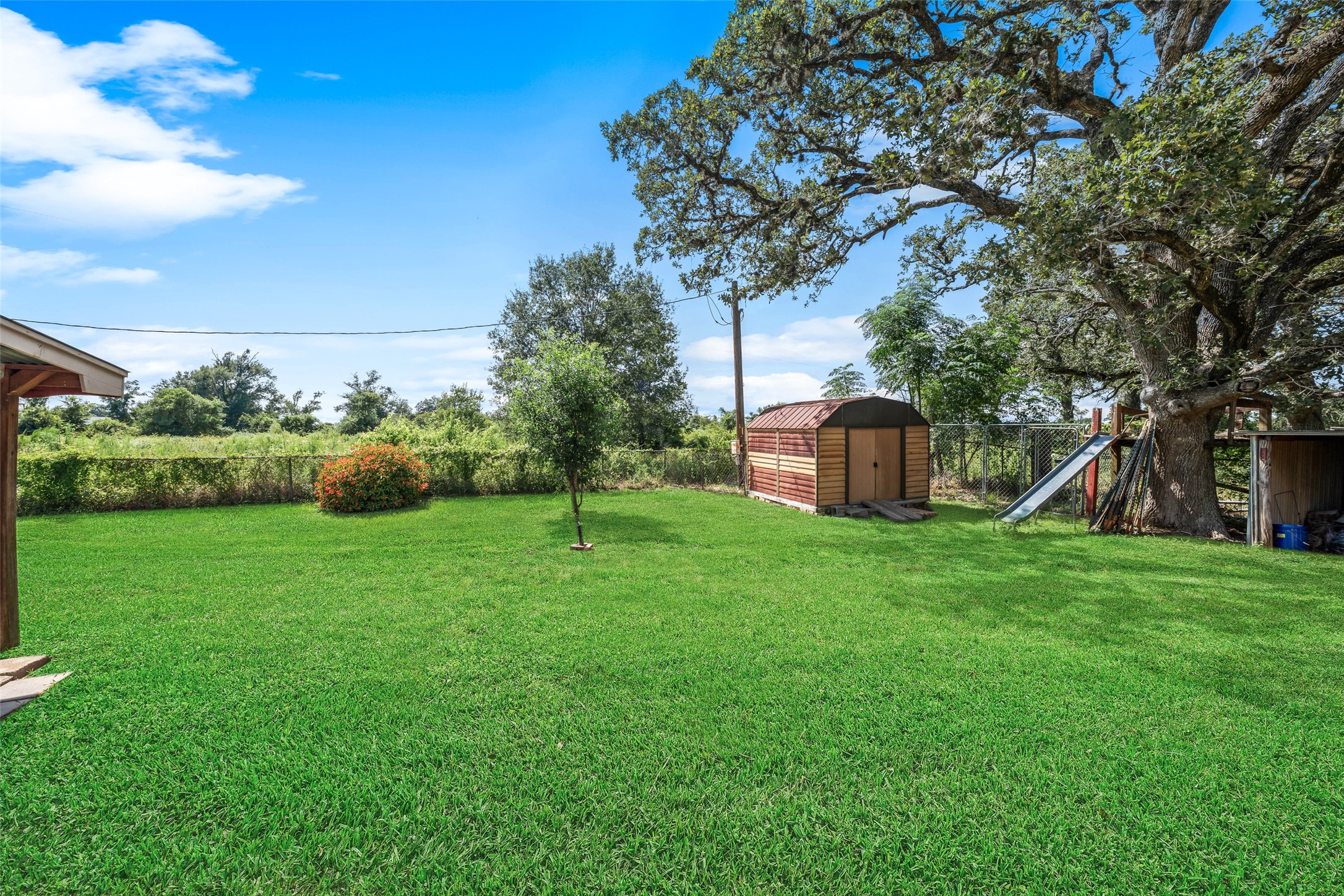 25739 Old Howth Road Hempstead, TX 77445 - Photo 27 of 36 A wide stretch of green lawn, mature shade trees and a handy storage shed create plenty of room for outdoor play, gardening, pets and relaxed country living.