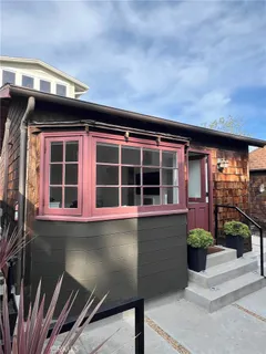 a front view of a house with a large window