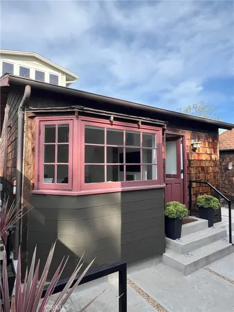 a front view of a house with a large window