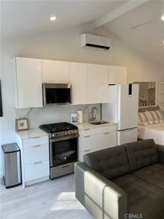 a kitchen with a stove a sink and a refrigerator