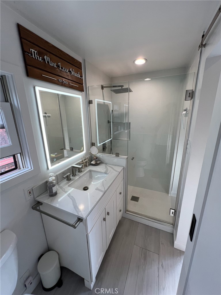388 Hawthorne Road, Unit A Laguna Beach, CA 92651 - Photo 12 of 19 a bathroom with a sink vanity mirror and toilet