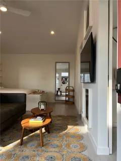 a living room with furniture a flat screen tv and a fireplace