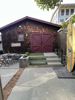 a view of backyard with a table and chairs and a fire pit