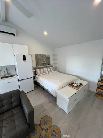 a bedroom with a bed and a couch