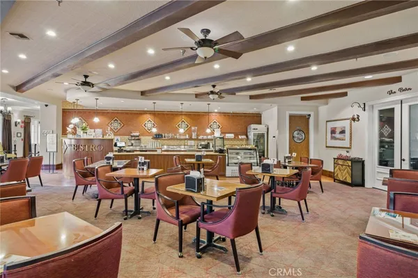 a room with pool table and windows