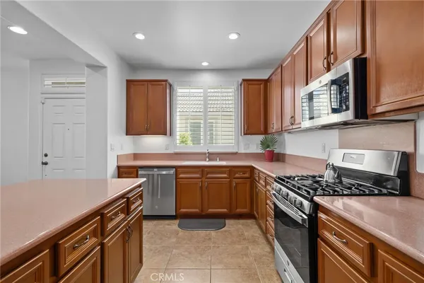 a kitchen with stainless steel appliances granite countertop a stove and a sink