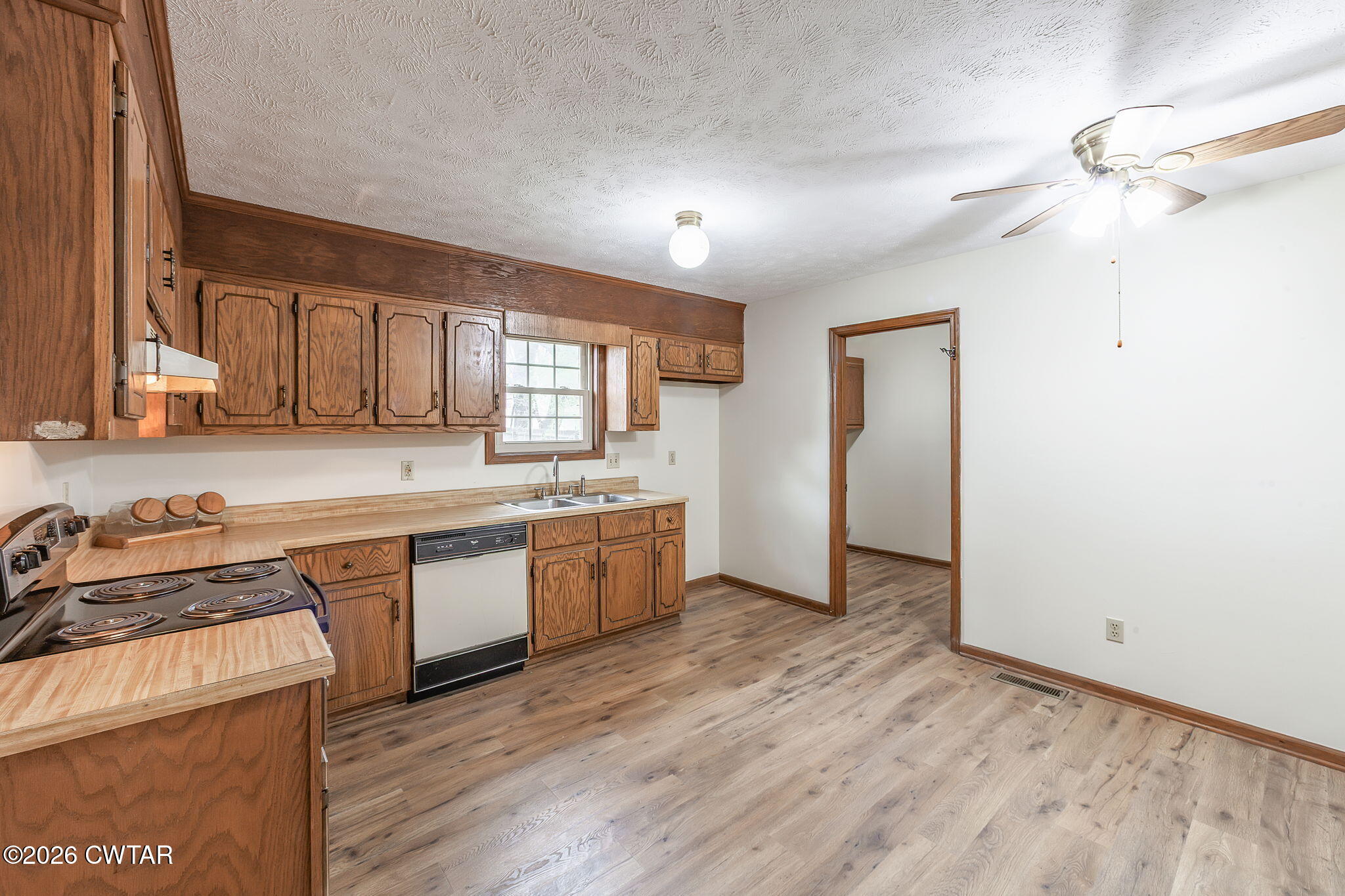 222 Dustin Drive Jackson, TN 38301 - Photo 12 of 30 a kitchen with granite countertop a sink cabinets and wooden floor