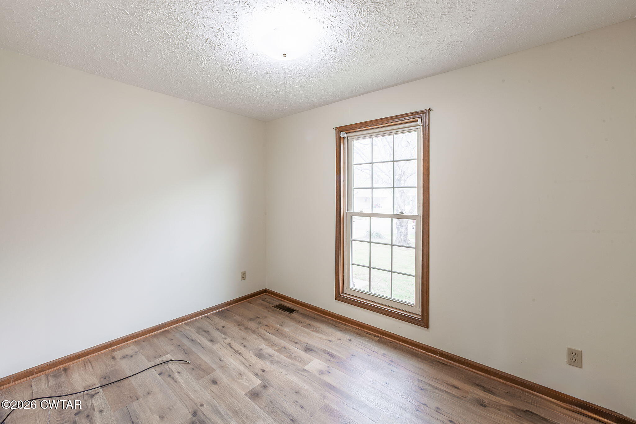 222 Dustin Drive Jackson, TN 38301 - Photo 16 of 30 an empty room with wooden floor and windows