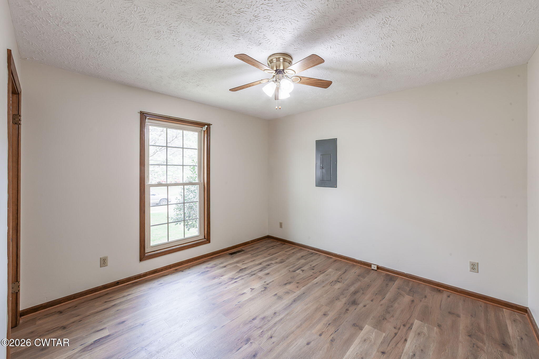 222 Dustin Drive Jackson, TN 38301 - Photo 18 of 30 an empty room with wooden floor chandelier fan and windows