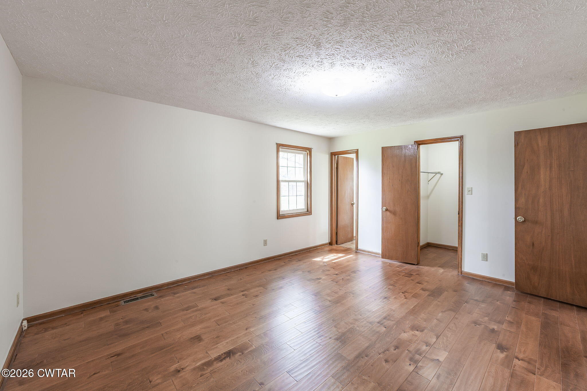 222 Dustin Drive Jackson, TN 38301 - Photo 22 of 30 an empty room with wooden floor and windows