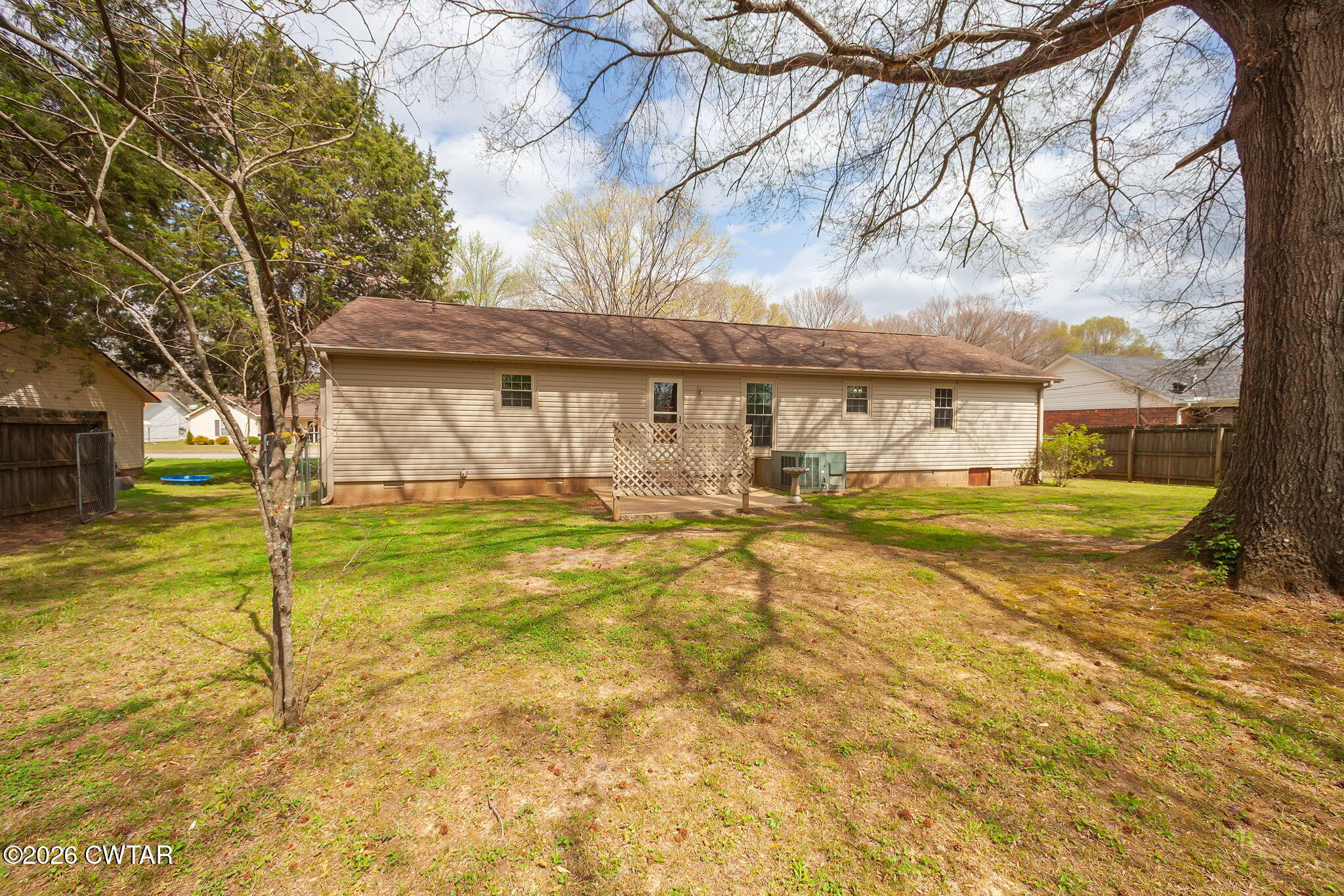 222 Dustin Drive Jackson, TN 38301 - Photo 24 of 30 a view of swimming pool with large trees and wooden fence