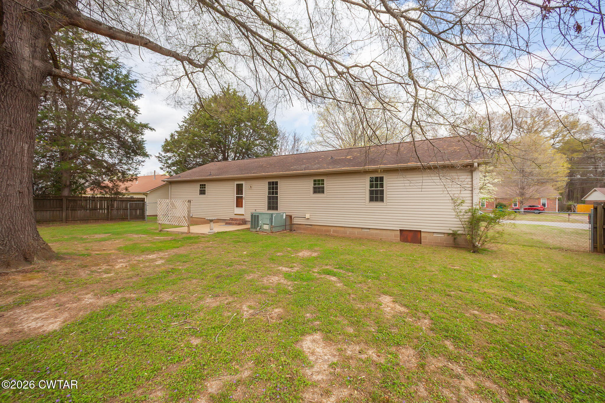 222 Dustin Drive Jackson, TN 38301 - Photo 27 of 30 a front view of house with yard and trees in the background