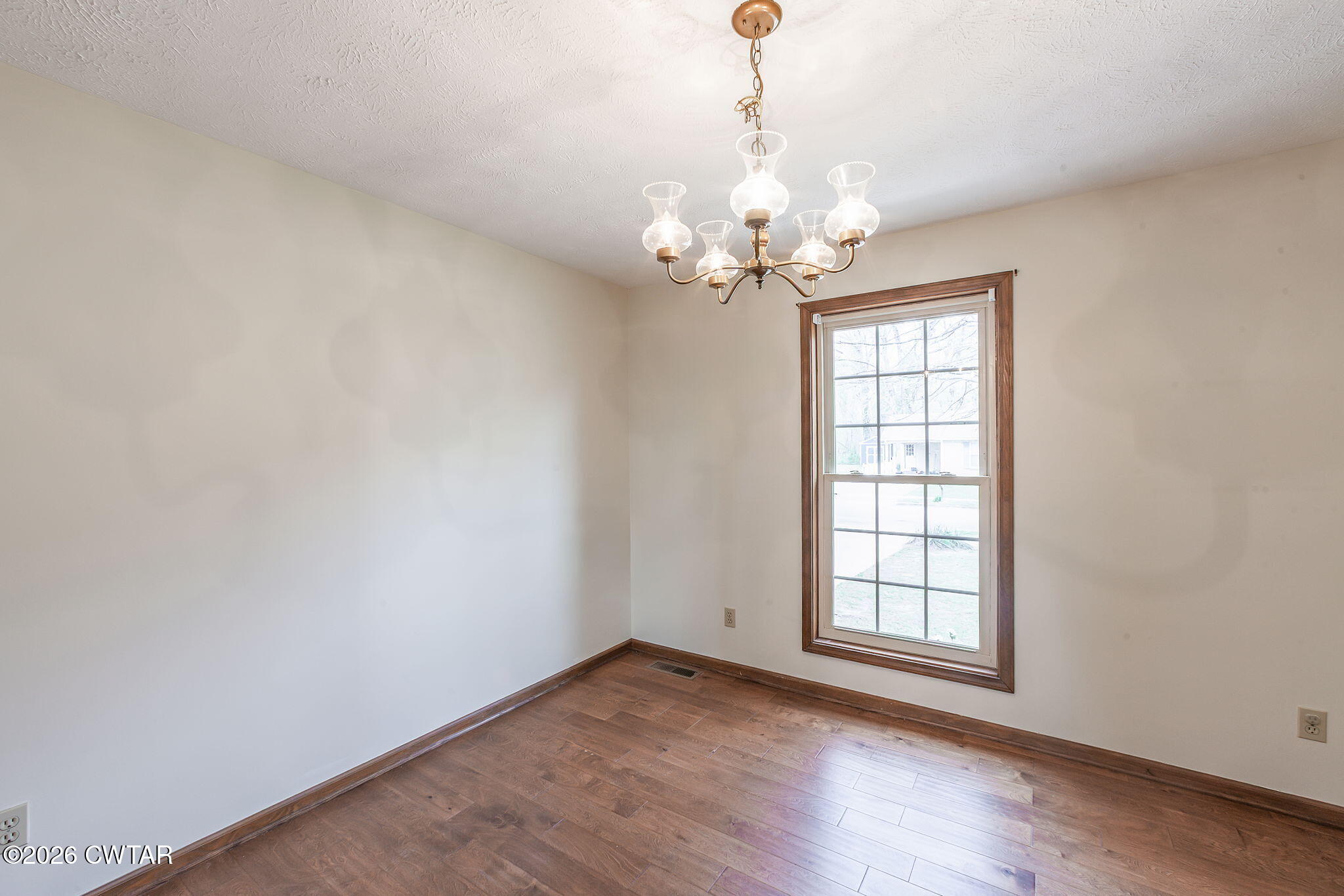 222 Dustin Drive Jackson, TN 38301 - Photo 8 of 30 wooden floor in an empty room with a window