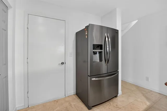 a metallic refrigerator freezer in a kitchen