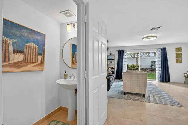 a picture of a livingroom with furniture and windows