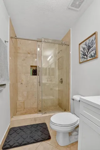 a bathroom with a toilet a shower and a sink