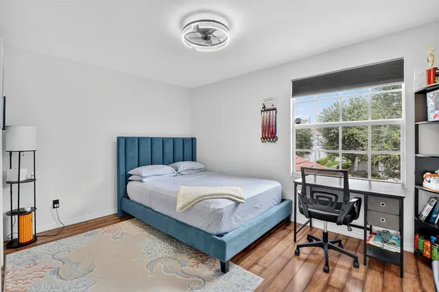 a bedroom with a bed and a window