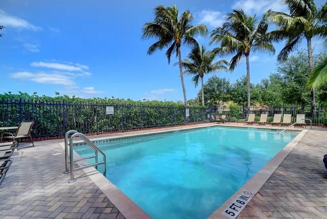 a view of a swimming pool with a table and chairs
