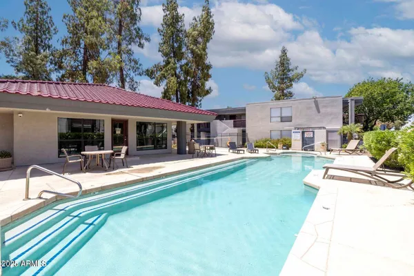 a view of a house with swimming pool and sitting area