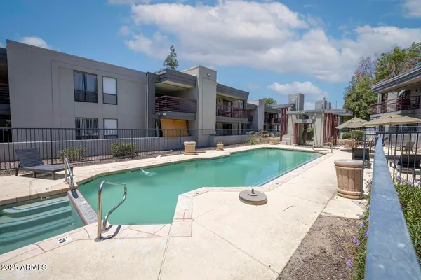 a chair and table sitting in backyard of the house