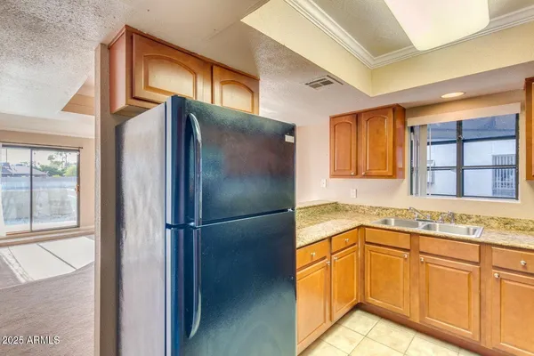 a kitchen with stainless steel appliances granite countertop a refrigerator and a sink