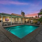 a front view of a house with swimming pool yard