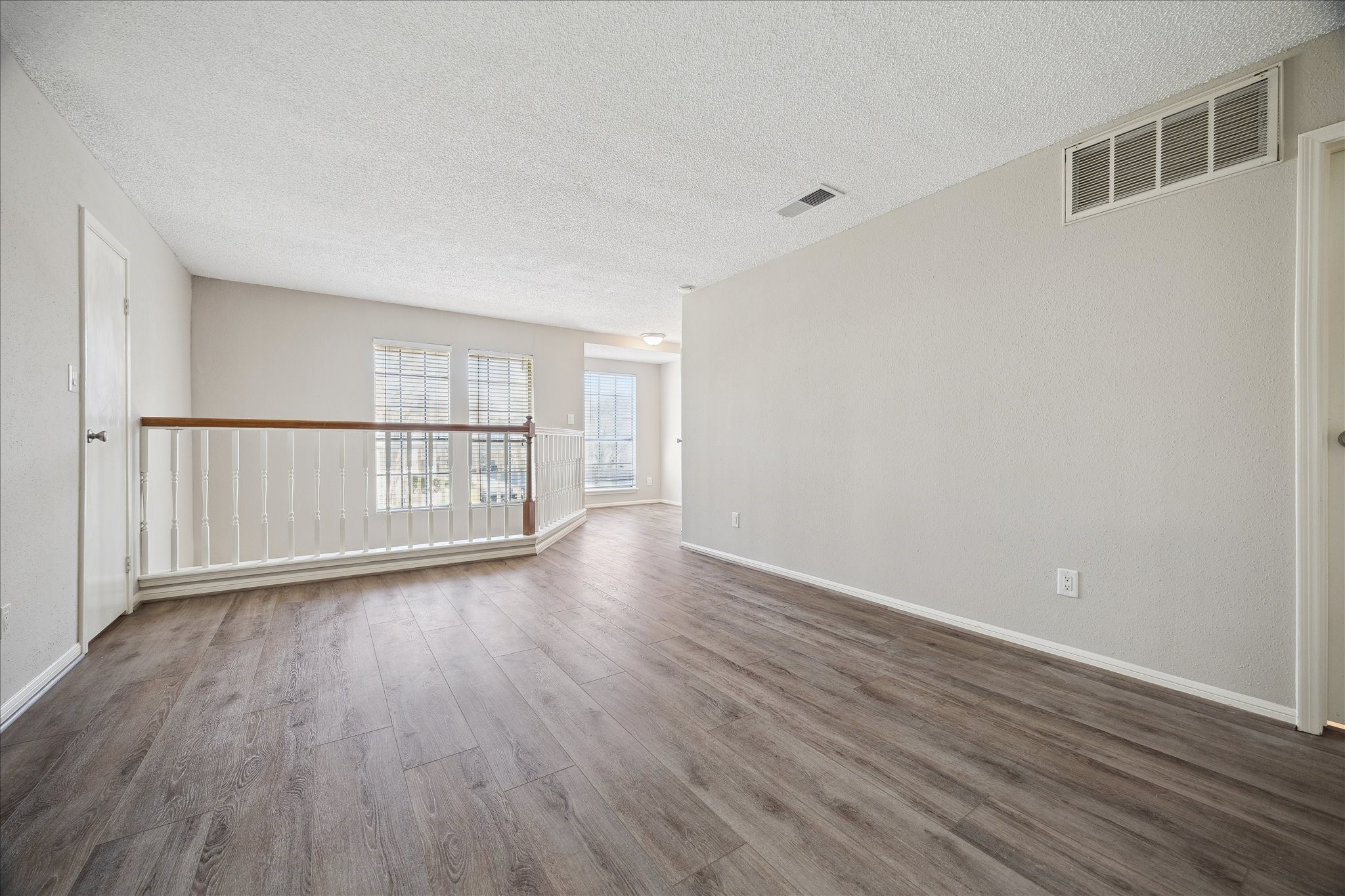 7575 Cambridge Street, Unit 1003 Houston, TX 77054 - Photo 15 of 27 a view of an empty room with wooden floor and a window
