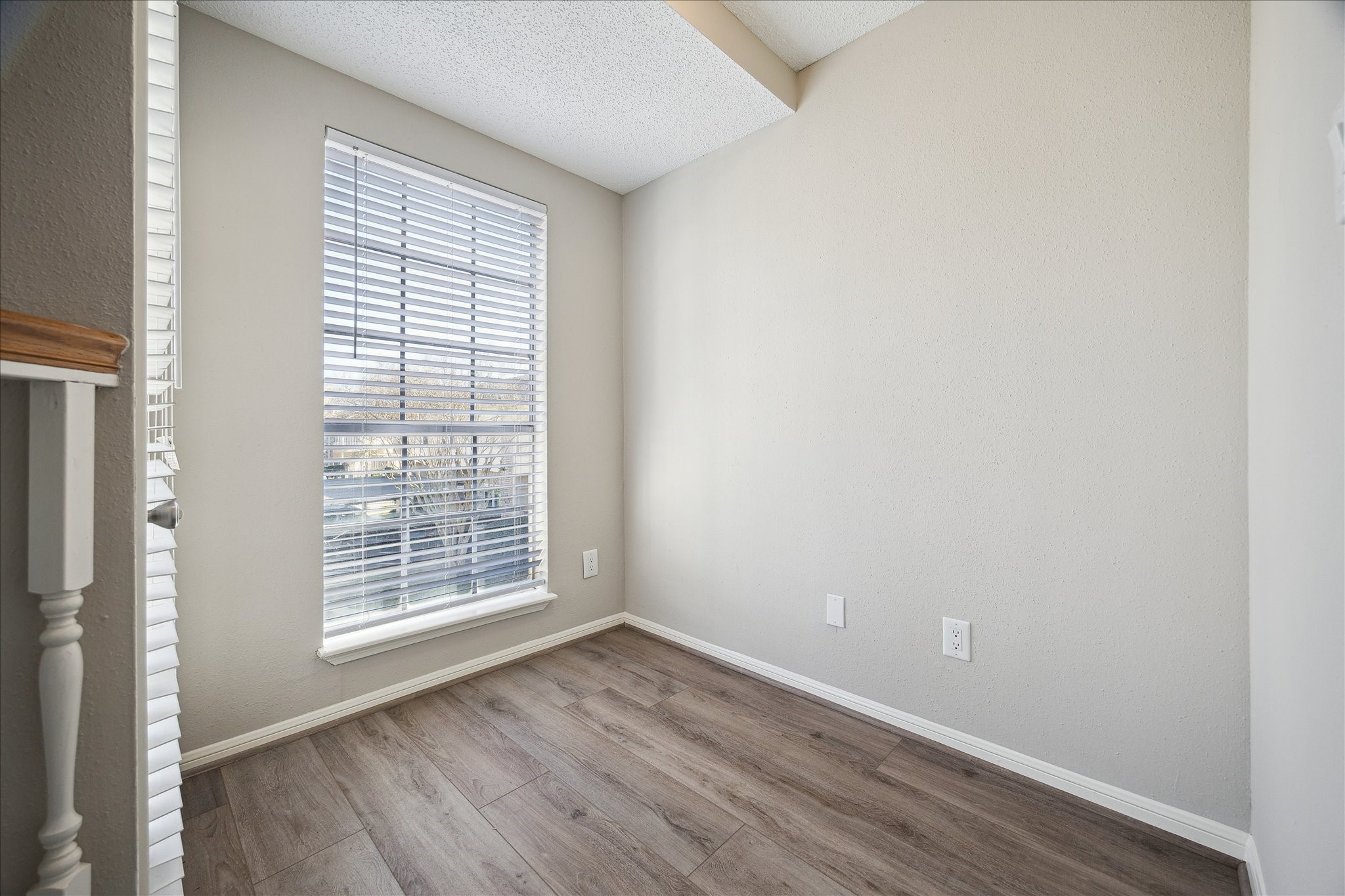 7575 Cambridge Street, Unit 1003 Houston, TX 77054 - Photo 22 of 27 an empty room with wooden floor and windows