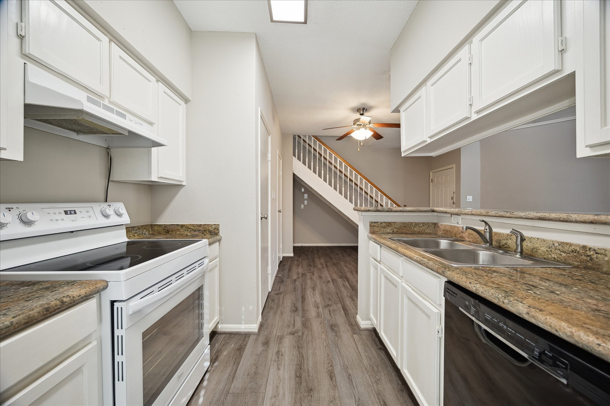 7575 Cambridge Street, Unit 1003 Houston, TX 77054 - Photo 5 of 27 a kitchen with a sink stove and cabinets