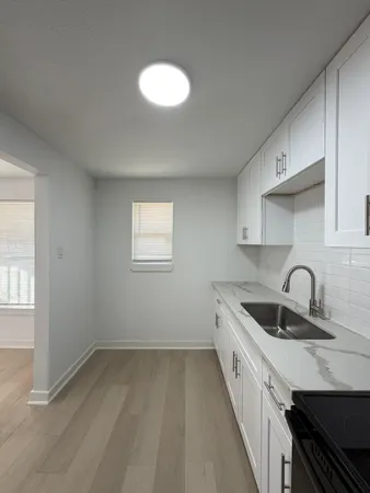 a kitchen with a refrigerator sink and cabinets