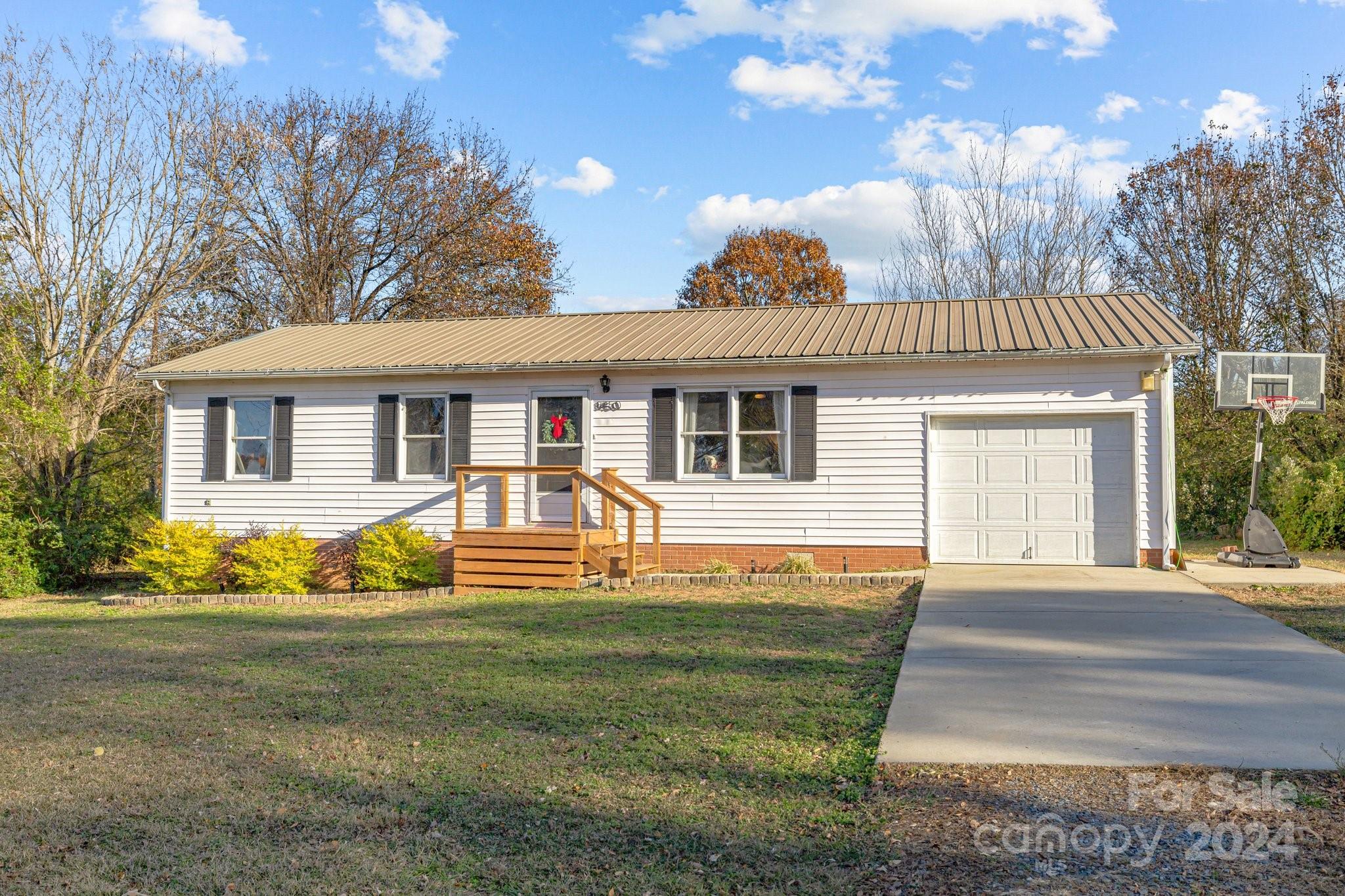 8450 Renee Ford Road Stanfield, NC 28163 - Photo 3 of 39 a front view of a house with a yard