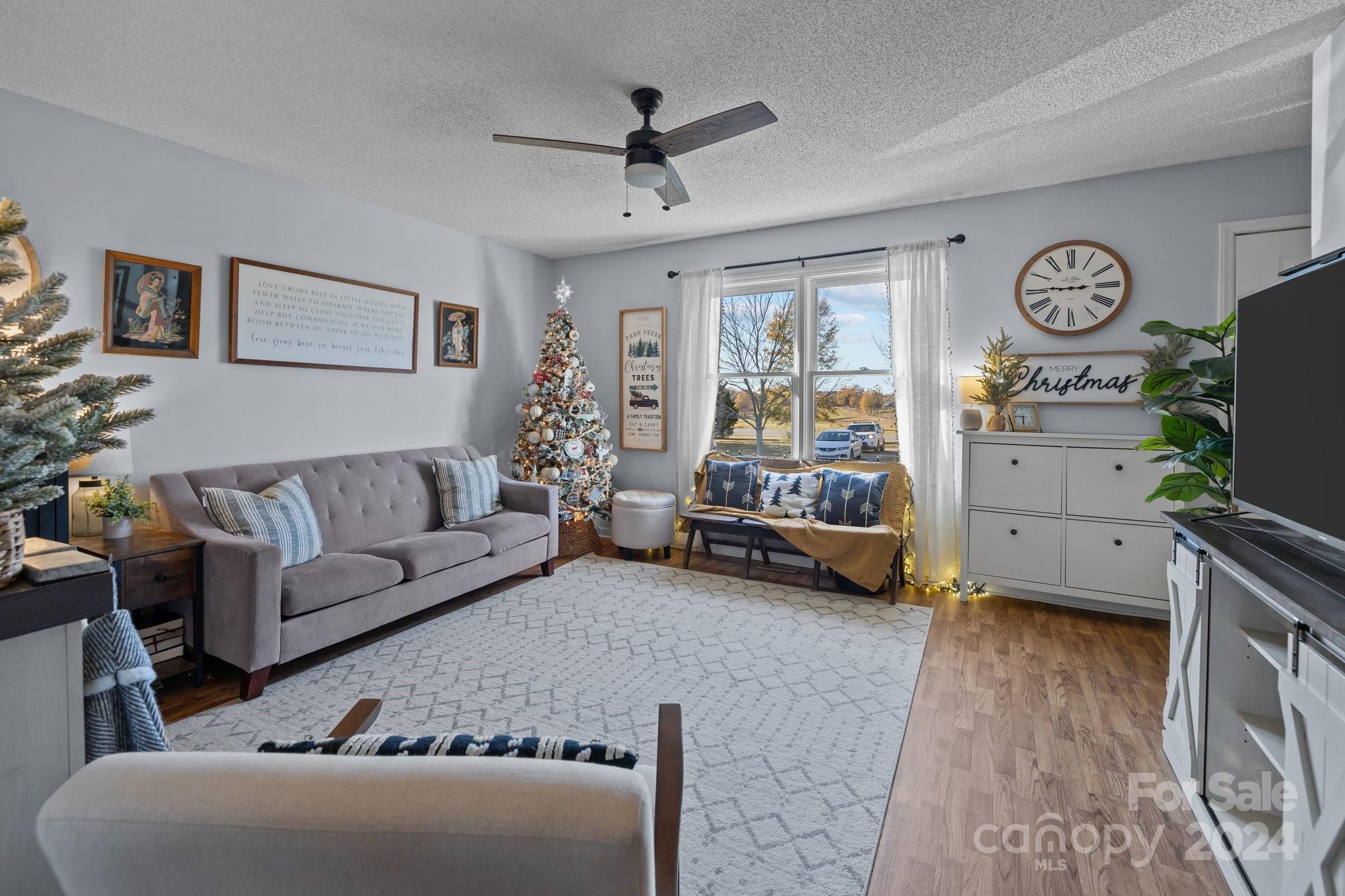 8450 Renee Ford Road Stanfield, NC 28163 - Photo 5 of 39 a living room with furniture and a flat screen tv