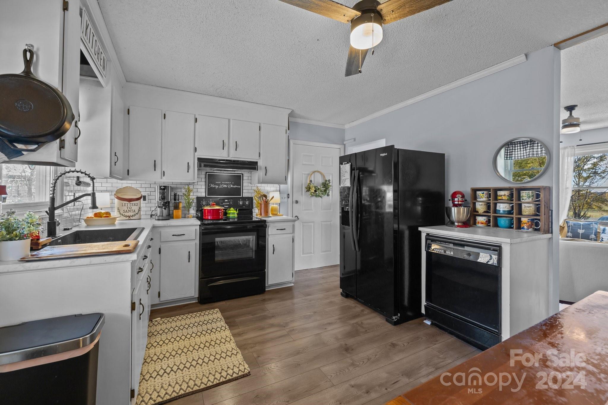8450 Renee Ford Road Stanfield, NC 28163 - Photo 10 of 39 a kitchen with granite countertop a refrigerator stove and sink