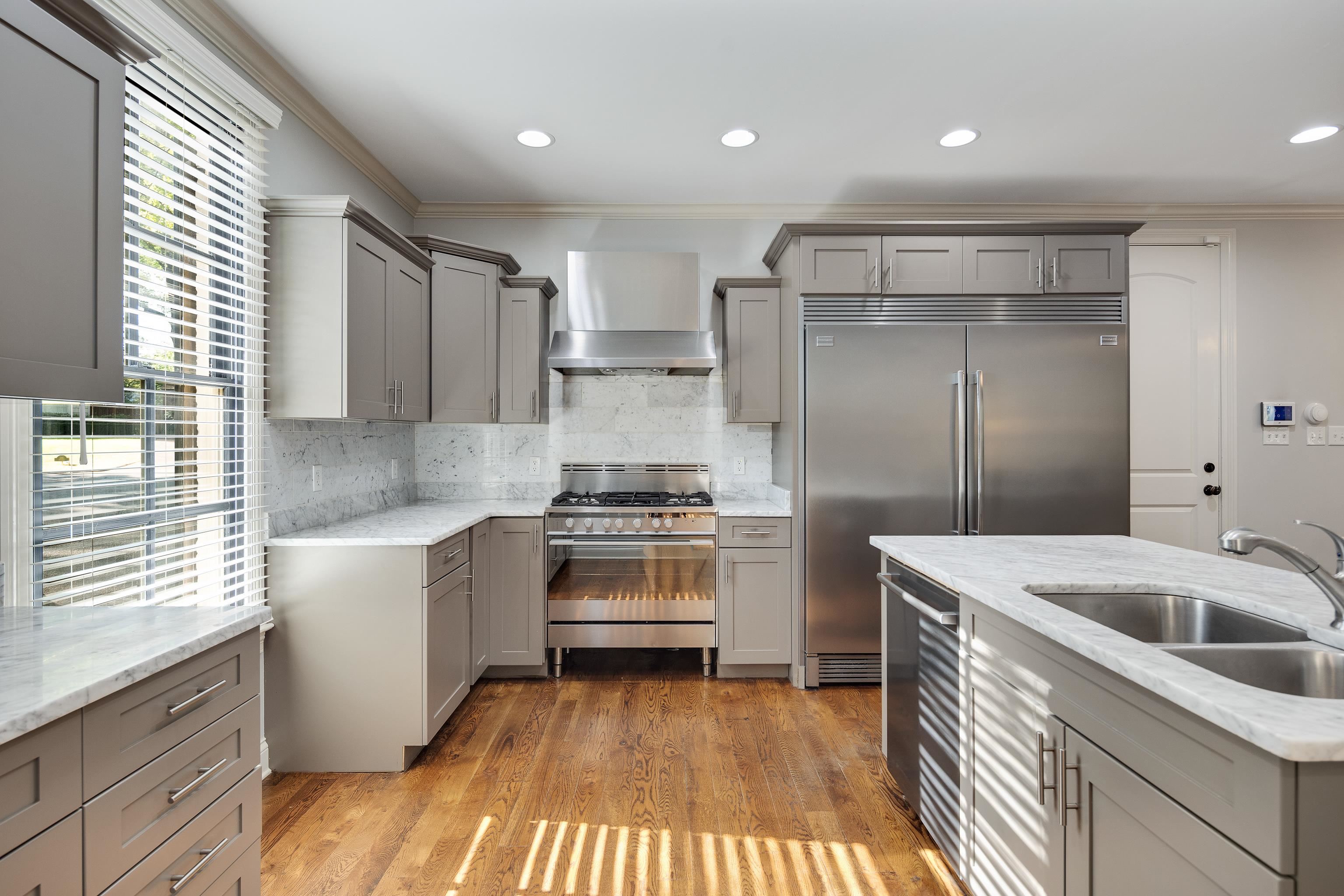 237 Windover Road Memphis, TN 38111 - Photo 5 of 37 Kitchen featuring gray cabinetry, ornamental molding, light stone counters, stainless steel appliances, and backsplash