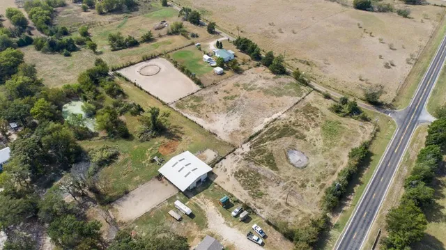 an aerial view of a house with a yard